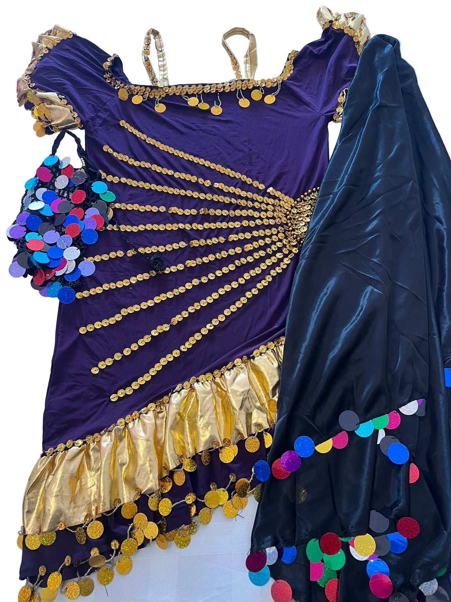 Purple and gold costume with colorful polka dot accents on a white surface