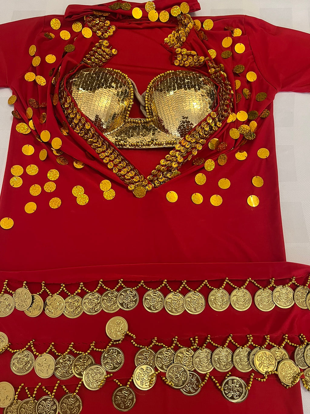 Red outfit with gold embellishments including a bra and coins on a white background