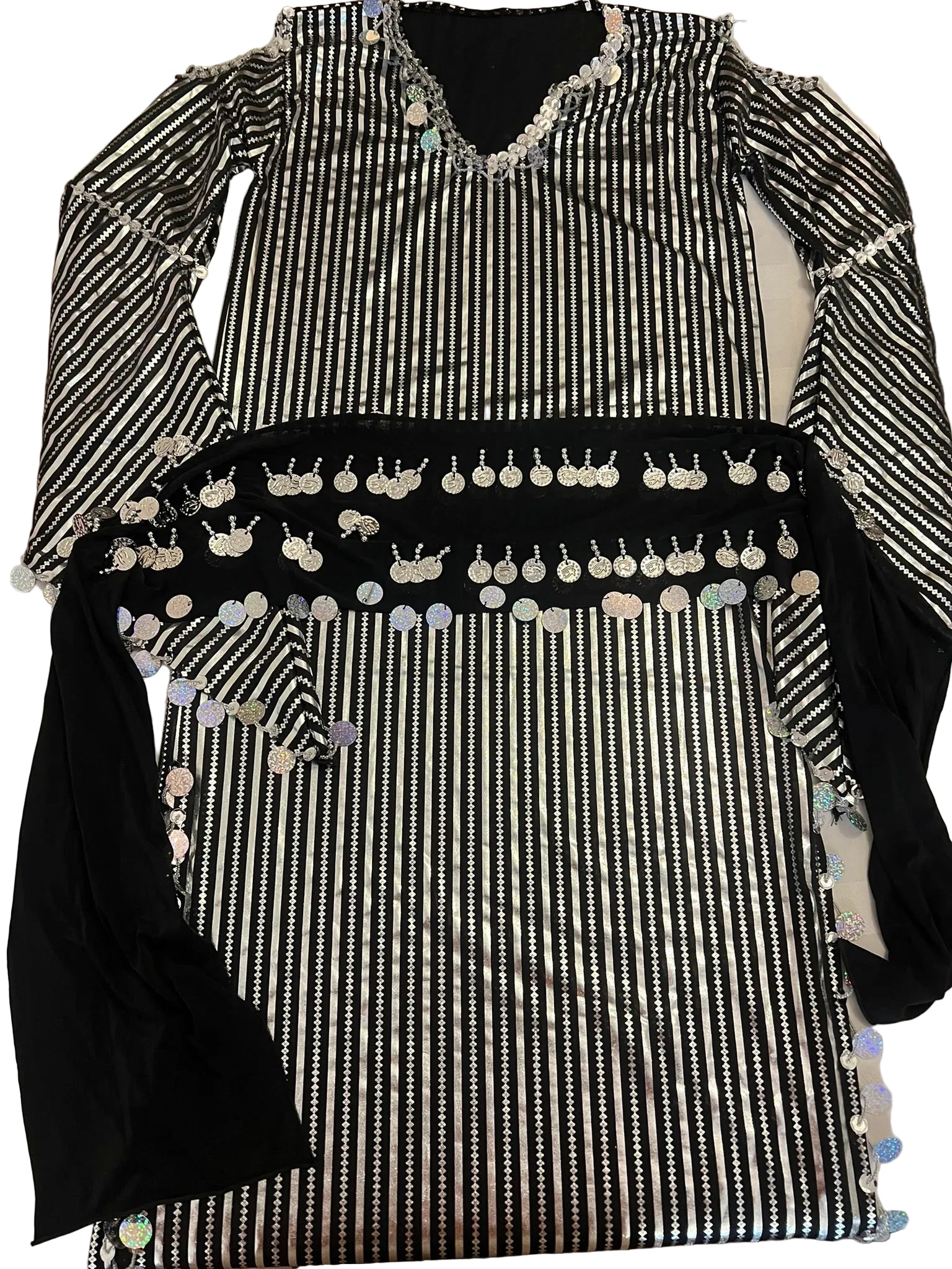 Black and white striped garment with decorative elements on a flat surface