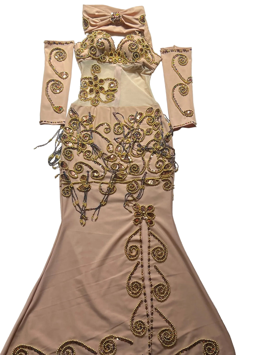 Beige evening gown with gold embroidery on a patterned surface