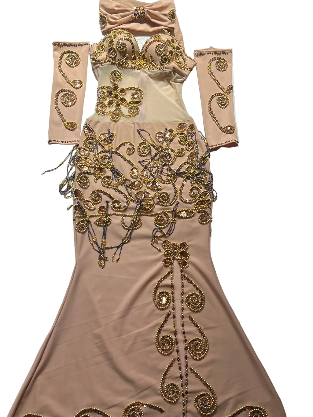 Beige evening gown with gold embroidery on a textured surface