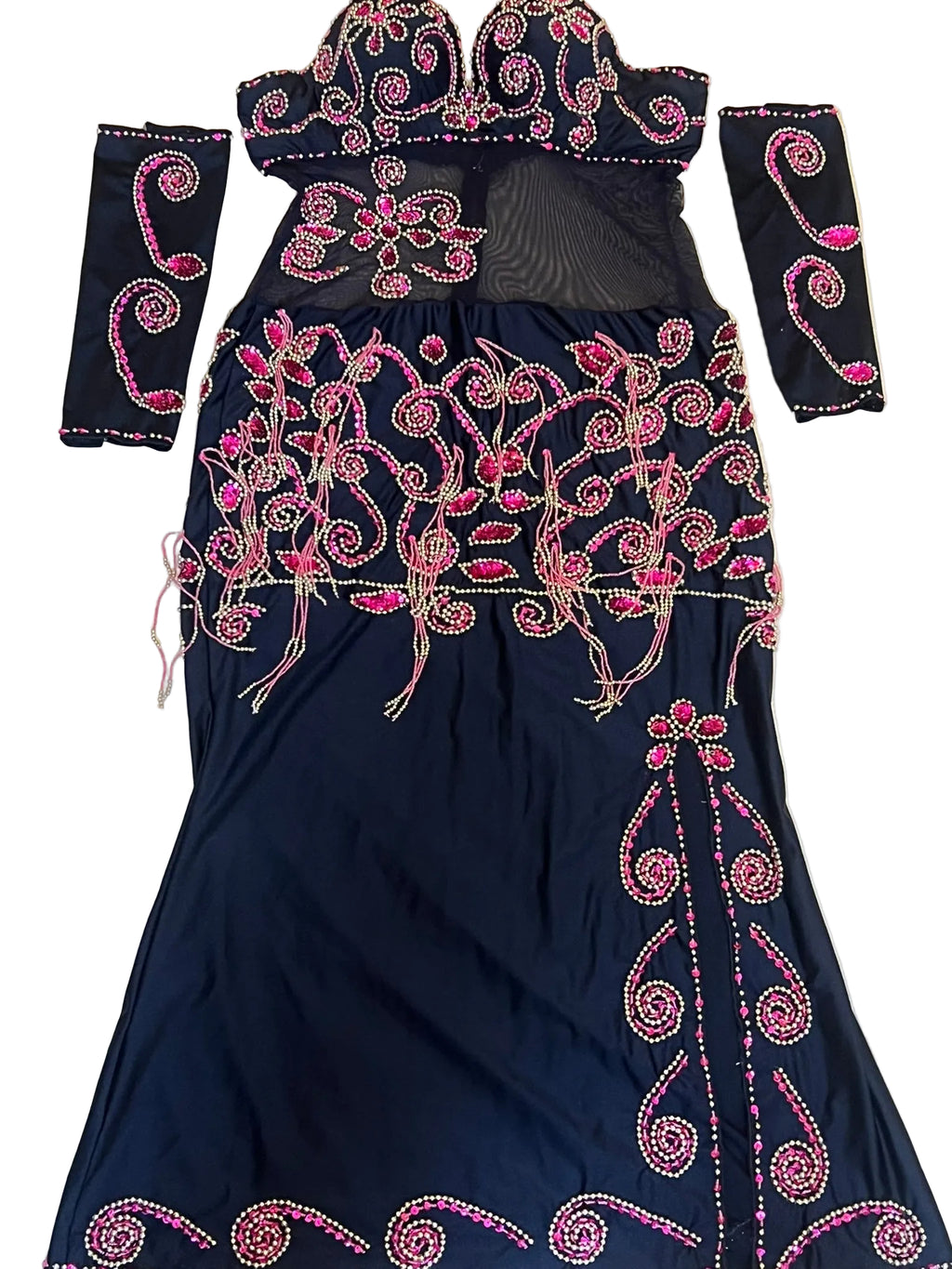 Black dress with pink embroidery on a beige background