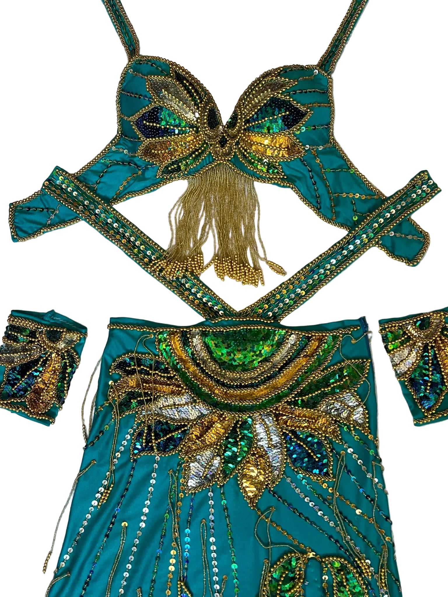 Decorative turquoise and gold costume piece on a light wooden surface