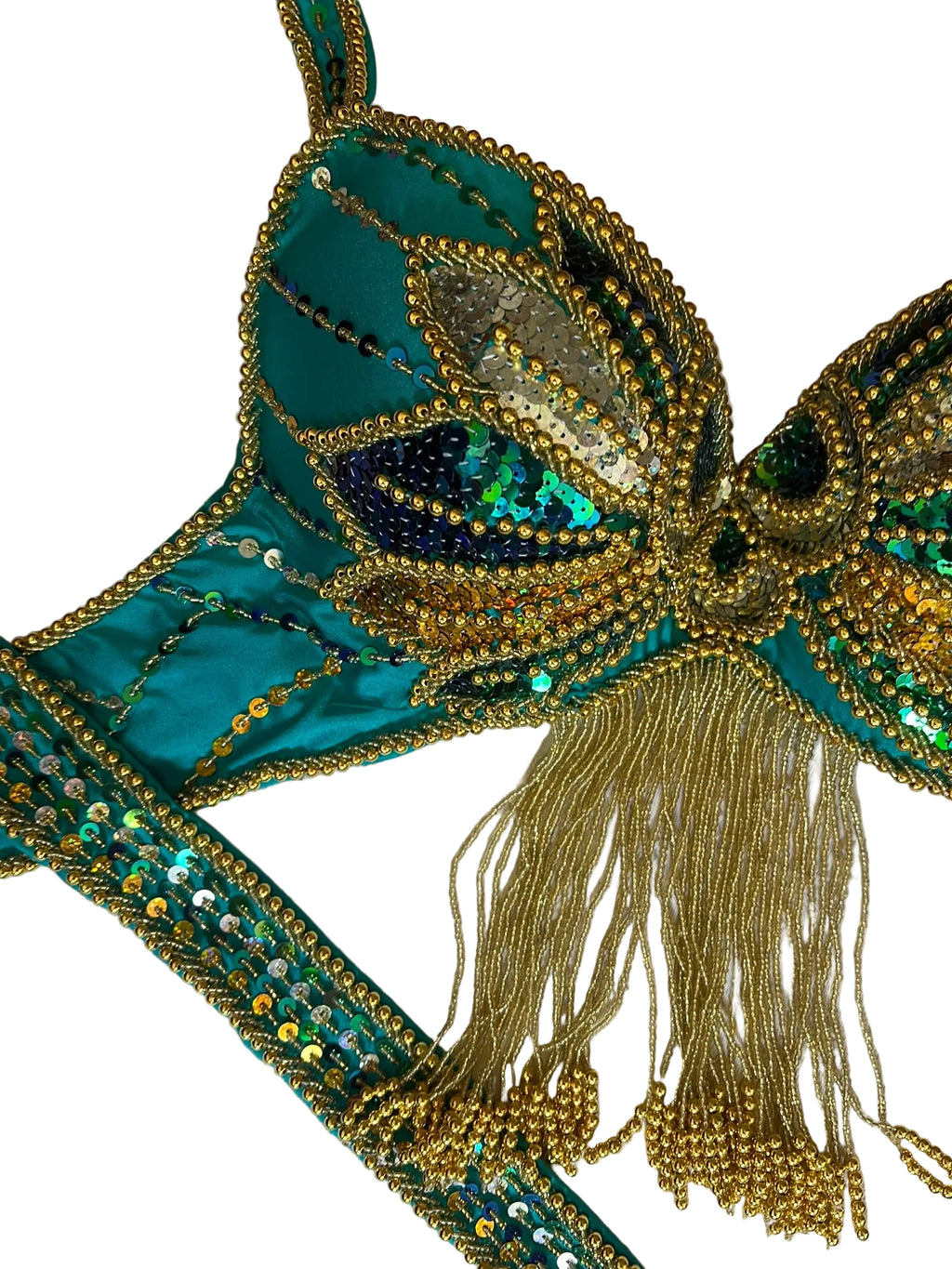 Decorative brooch with teal and gold colors on a textured background