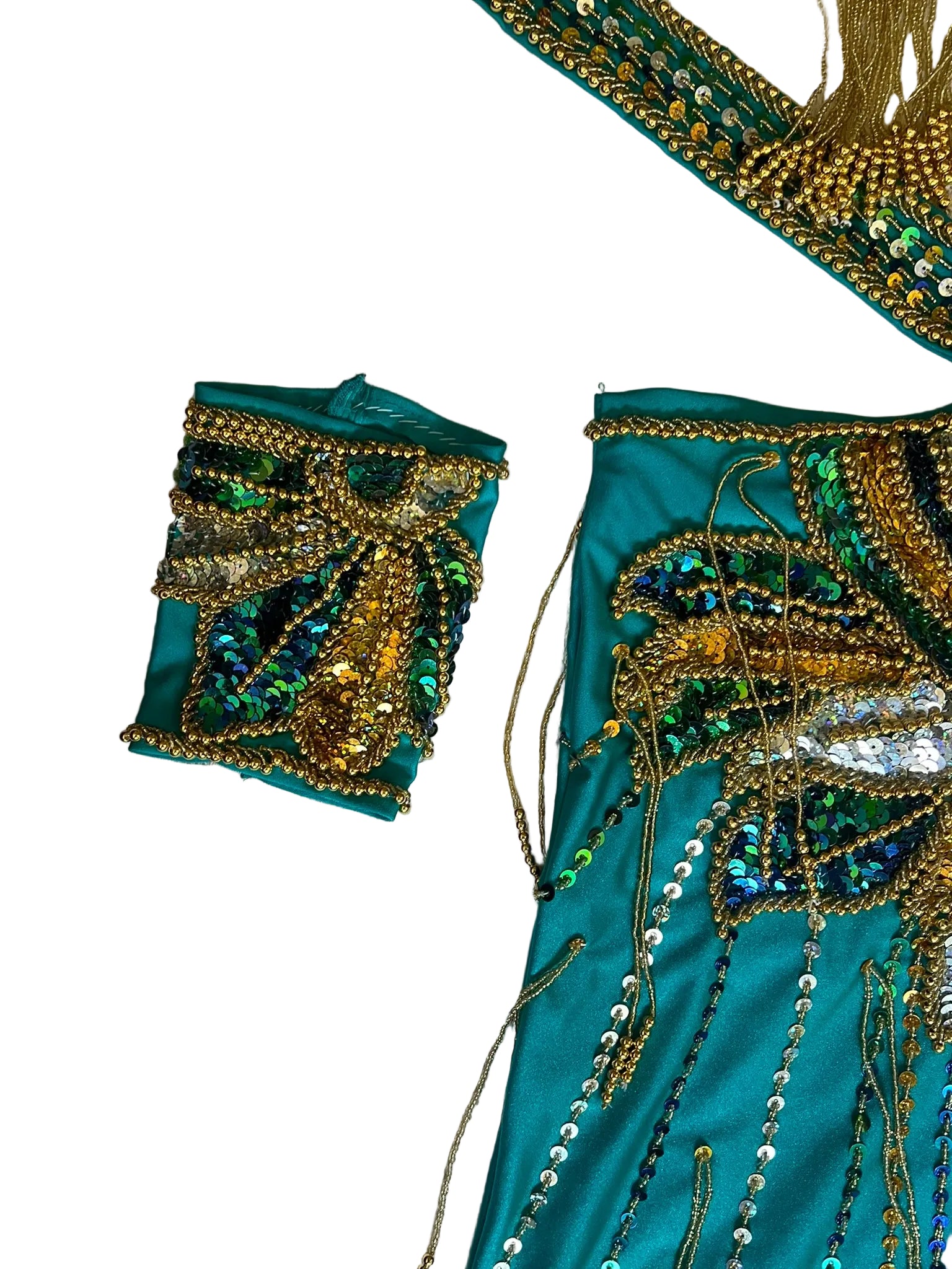 Teal fabric with gold and green embroidery on a textured white background