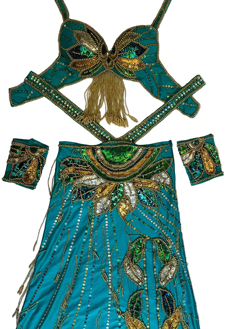 Turquoise costume with gold and green embellishments on a light wooden surface