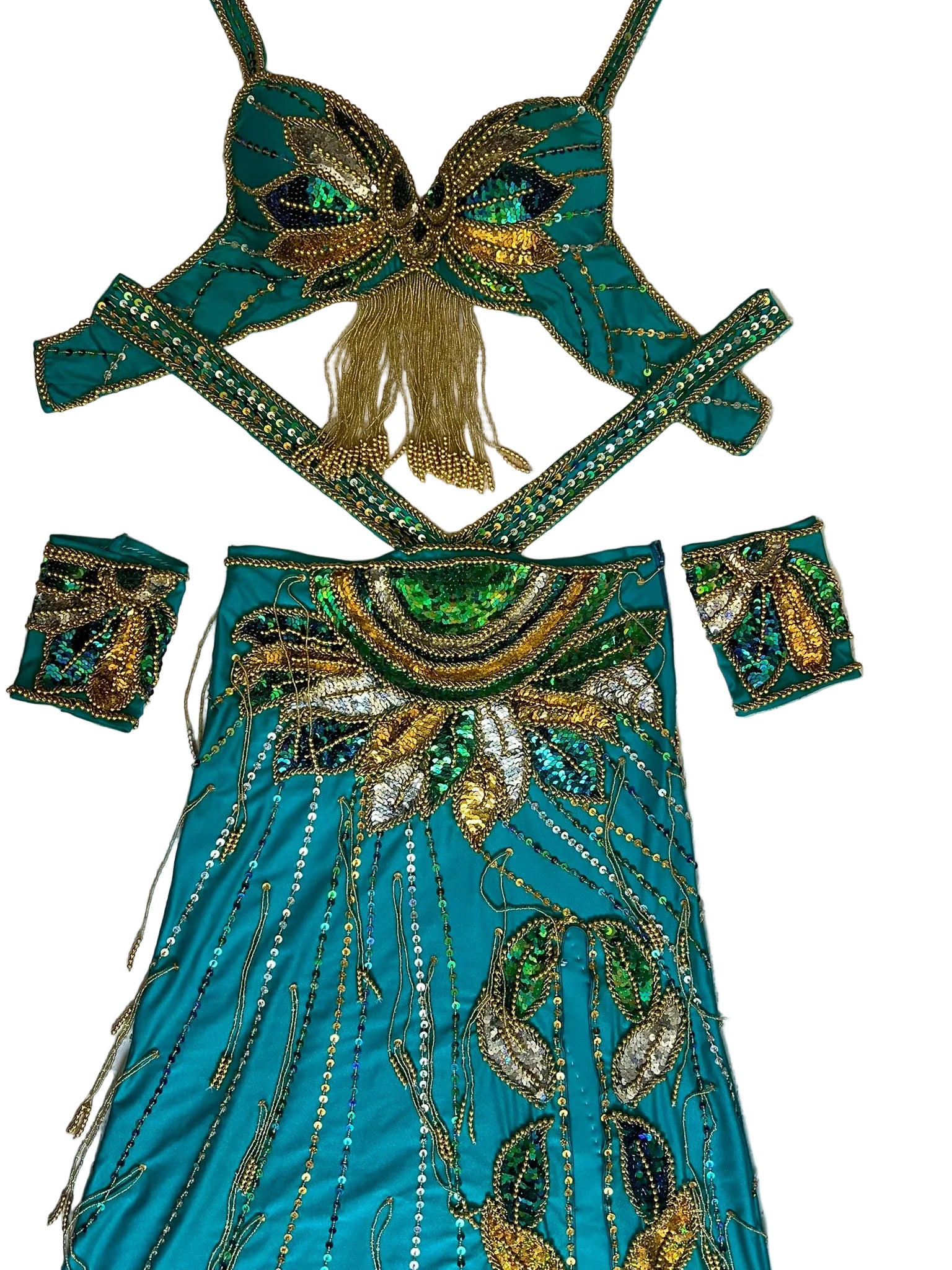 Turquoise costume with gold and green embellishments on a light wooden surface