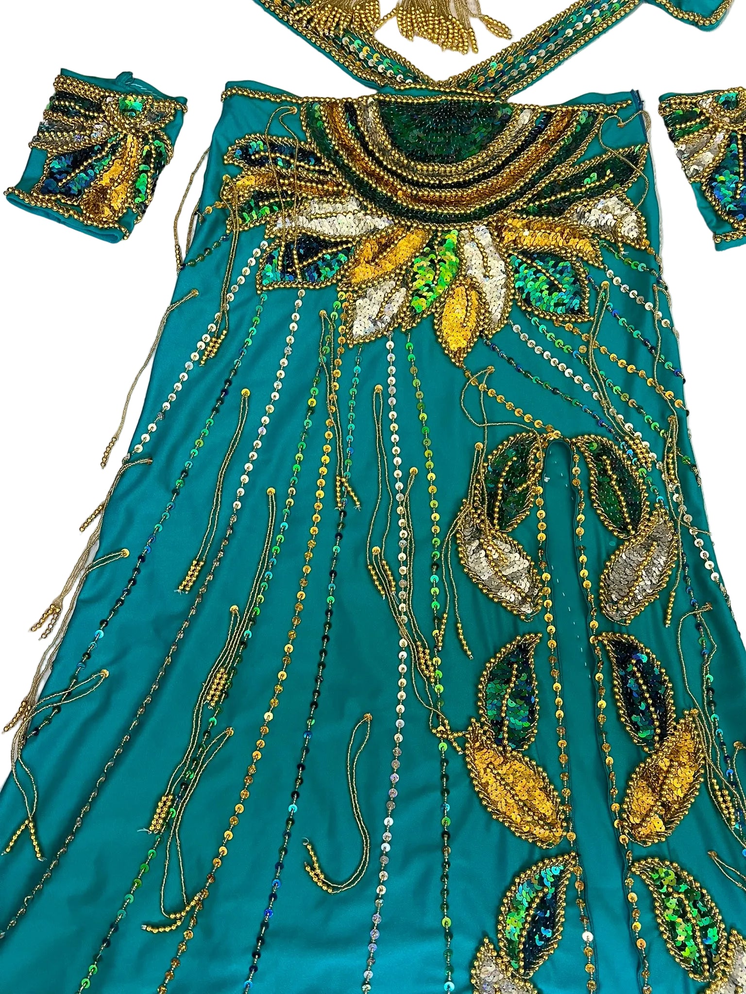Teal fabric with intricate gold and green embroidery on a white background