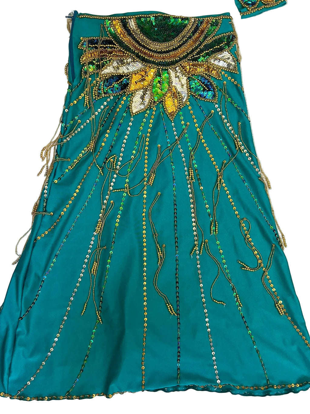 Teal fabric with gold and green embroidery on a light background