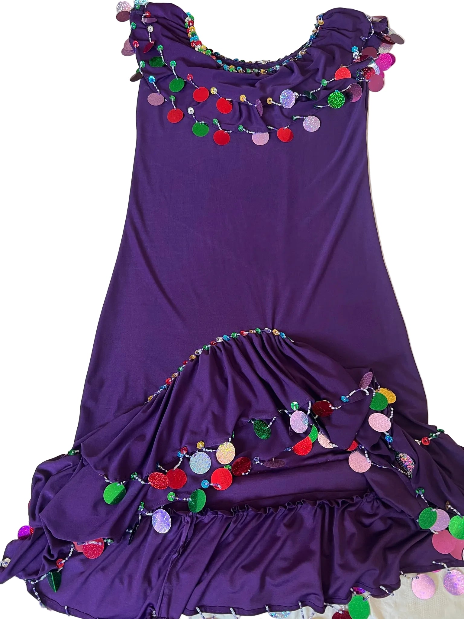 Purple dress with colorful pom-pom trim on a white background