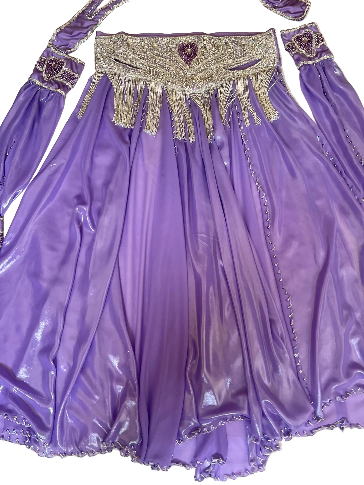 Purple dress with intricate beading and fringes on a textured surface