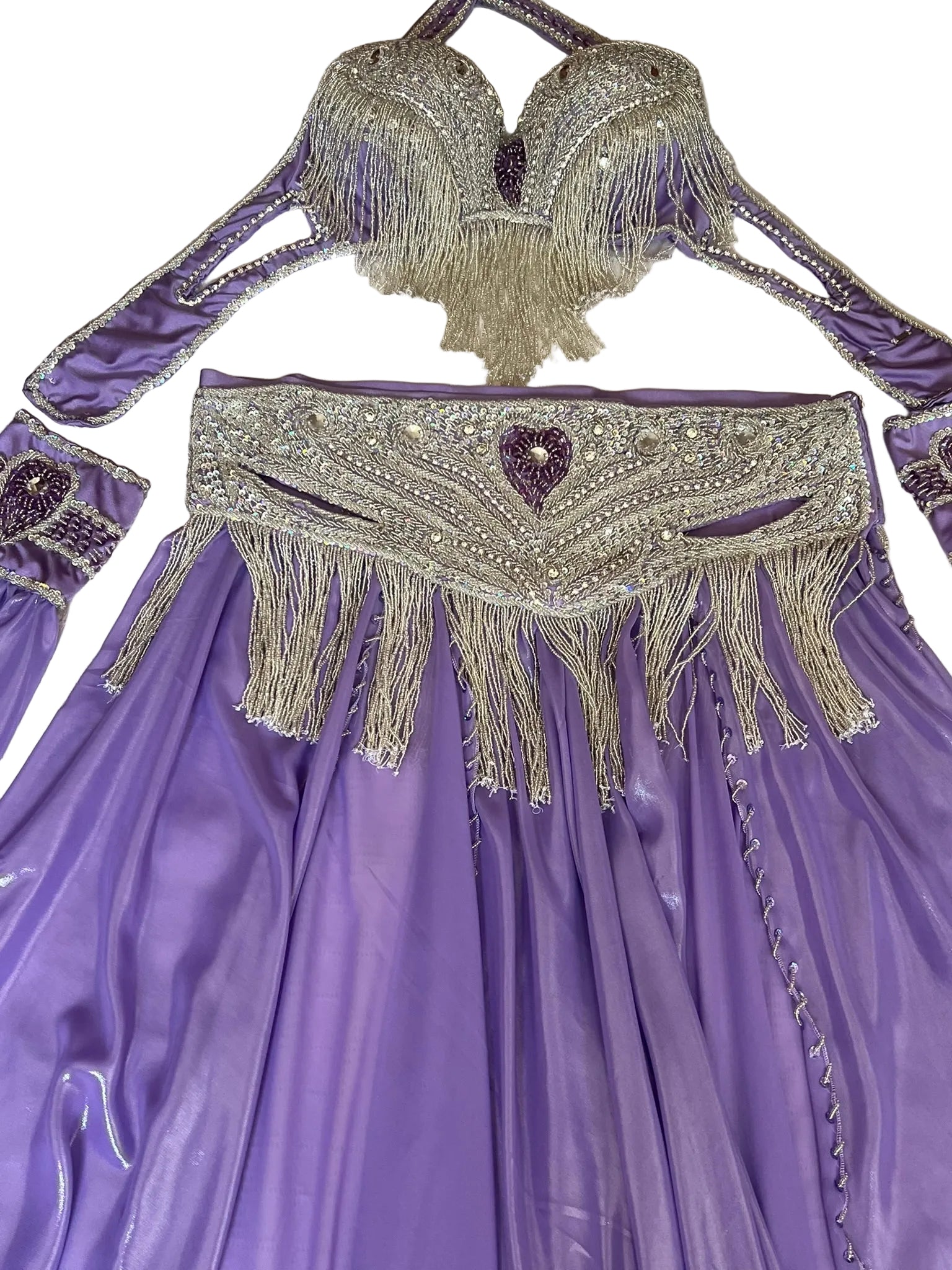 Purple costume with beaded top and belt on a white background