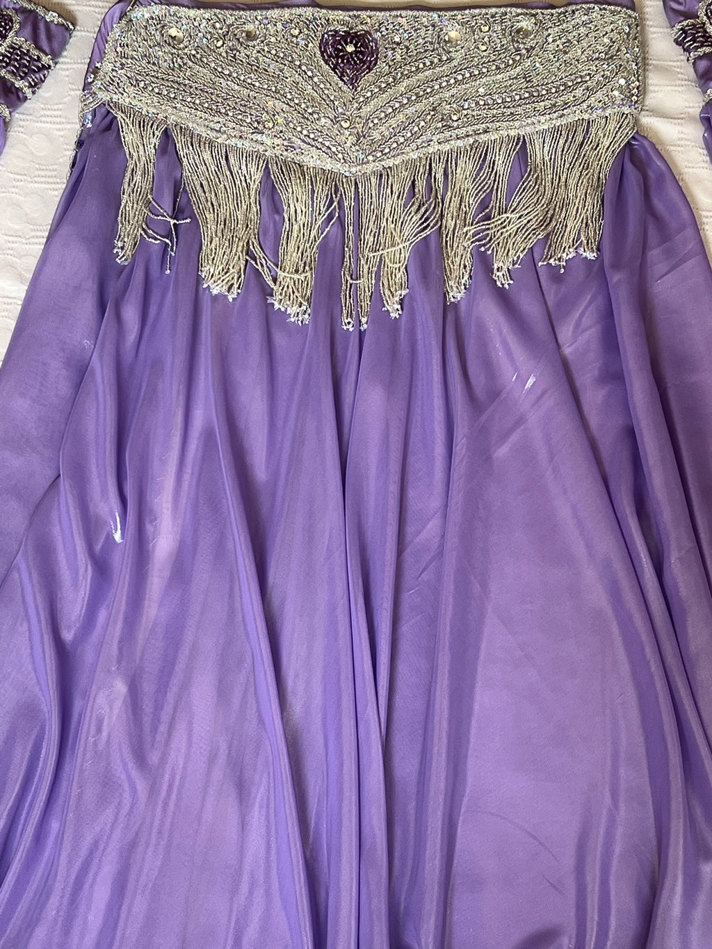 Purple fabric with a decorative top section featuring beads and tassels.