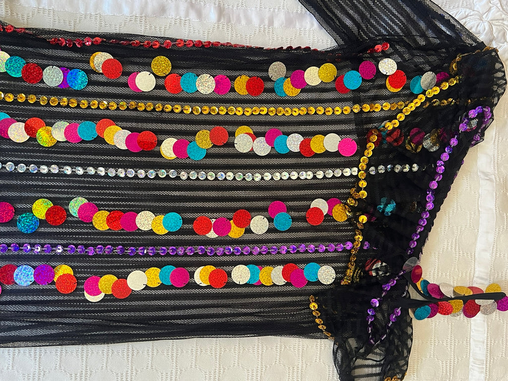 Black fabric with colorful sequin embellishments on a white background