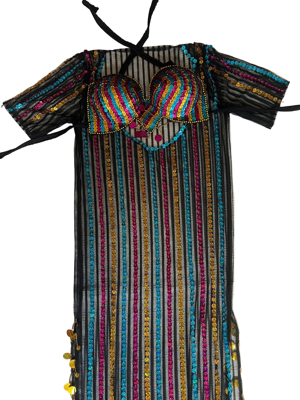 Colorful striped dress with a patterned top on a light wooden surface