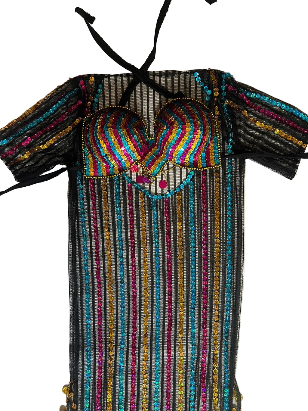 Colorful embroidered dress with a heart design on a textured surface