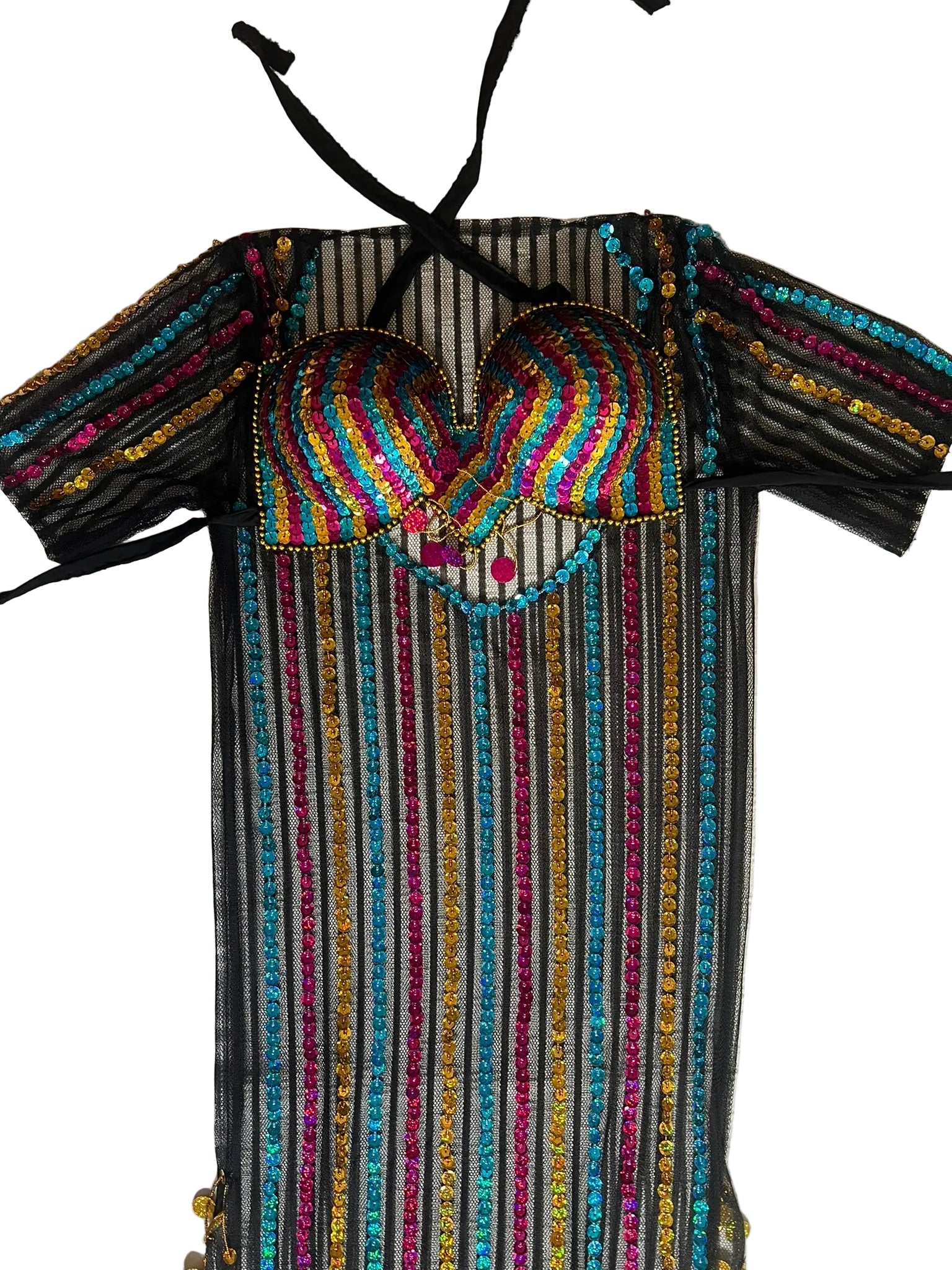 Colorful embroidered dress with a heart design on a textured surface