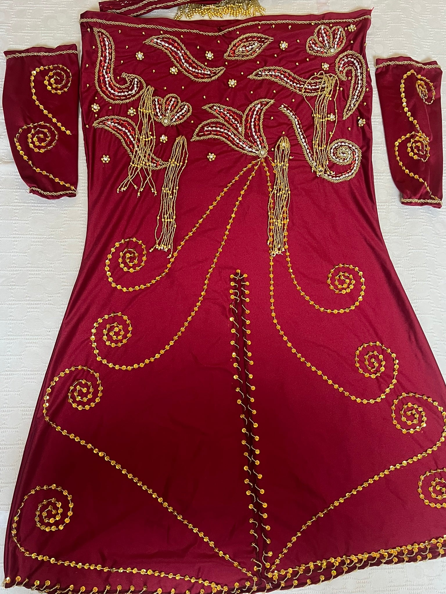 Maroon dress with gold embroidery on a white background