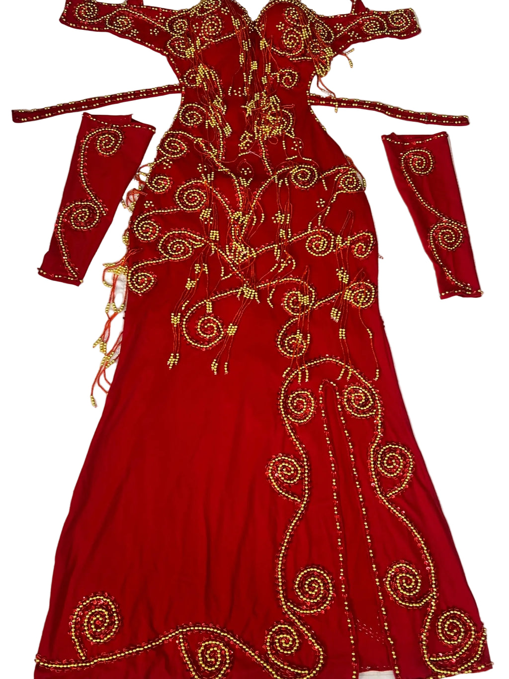 Red embroidered dress with gold patterns on a white background