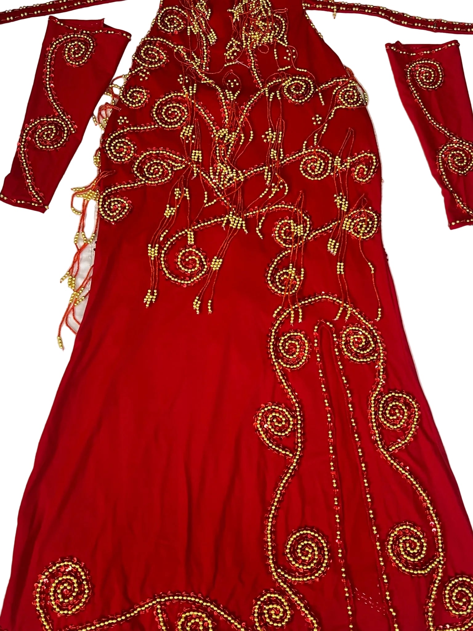 Red embroidered garment with gold patterns on a white background