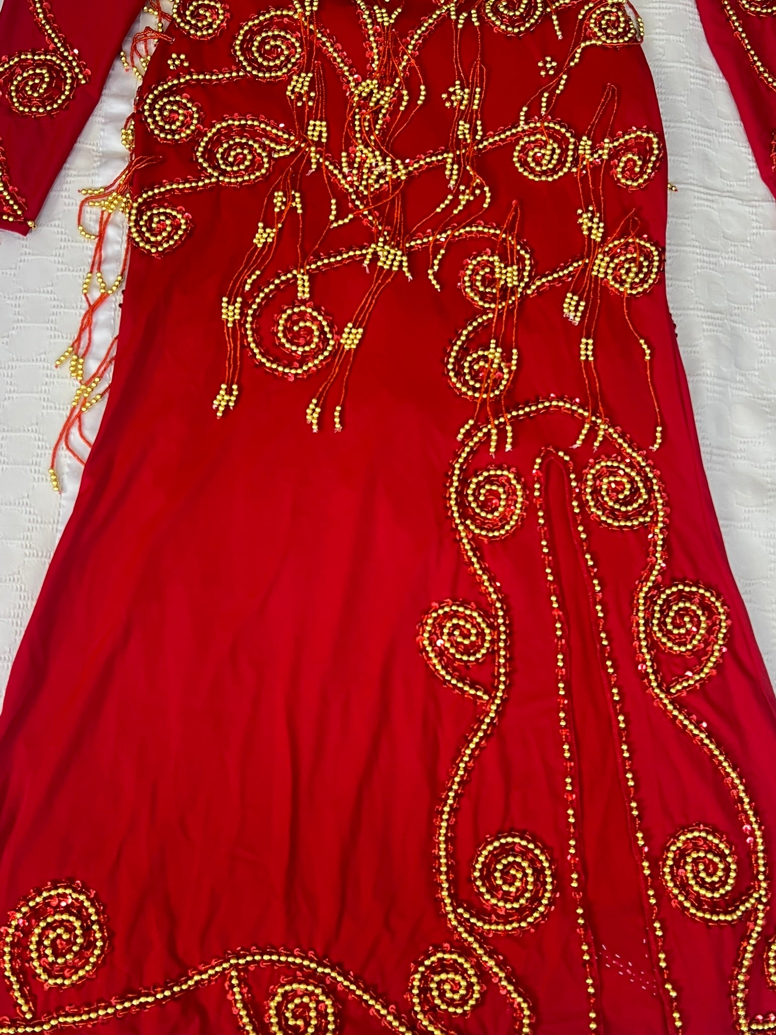 Red garment with gold embroidery on a white background