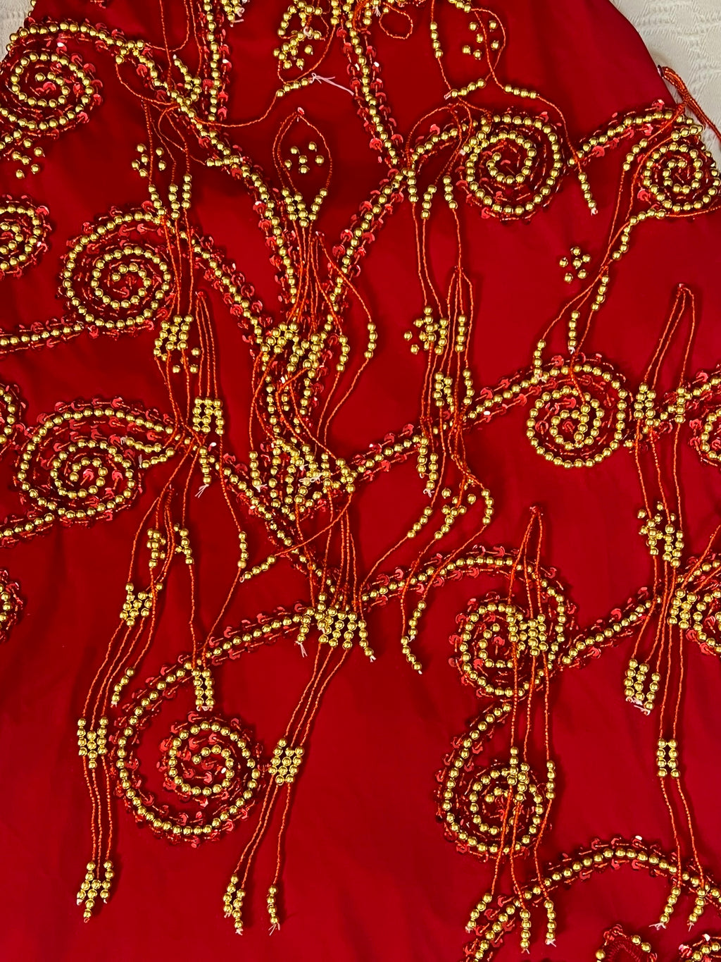 Red fabric with gold bead embroidery