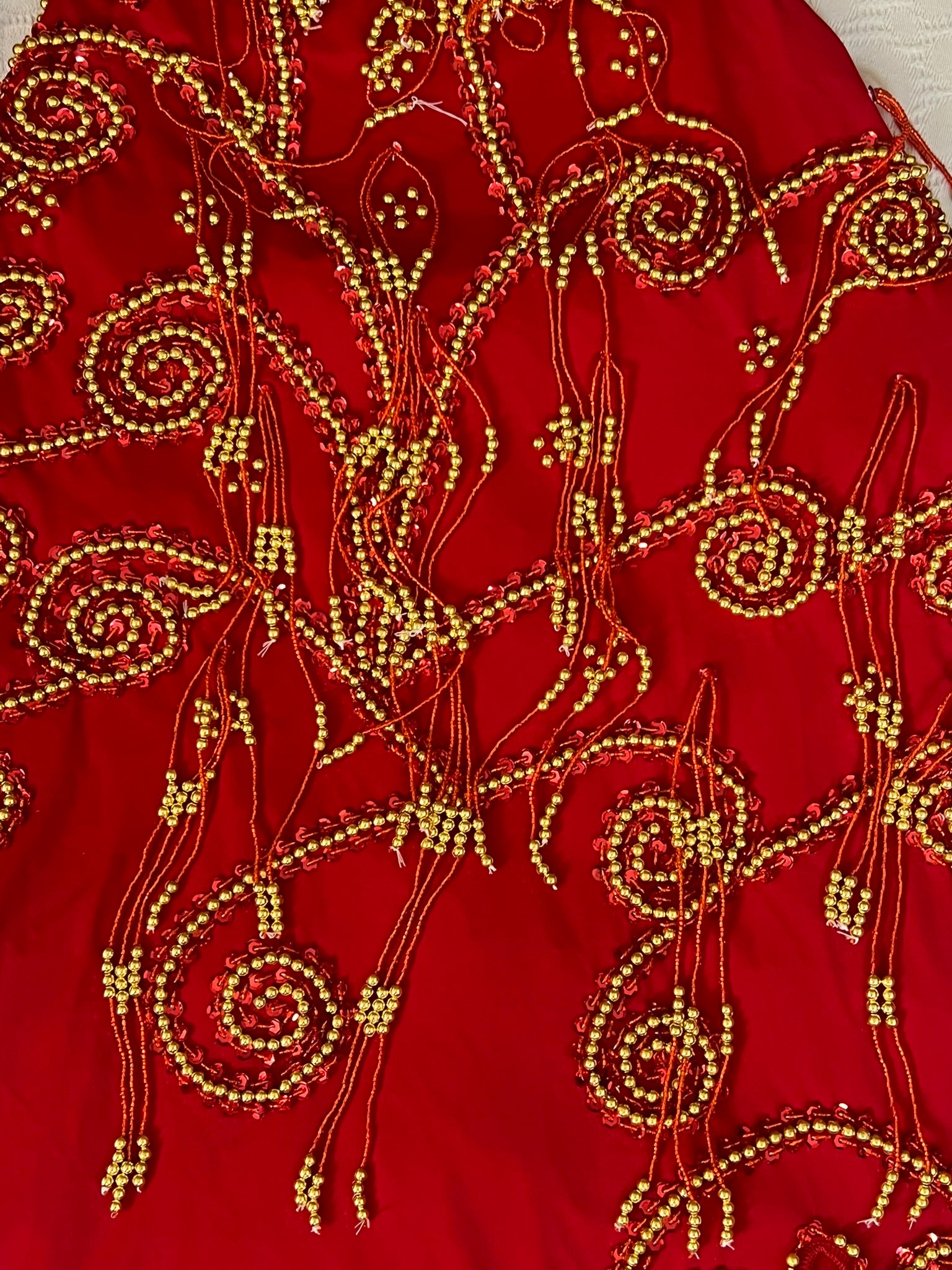 Red fabric with gold bead embroidery