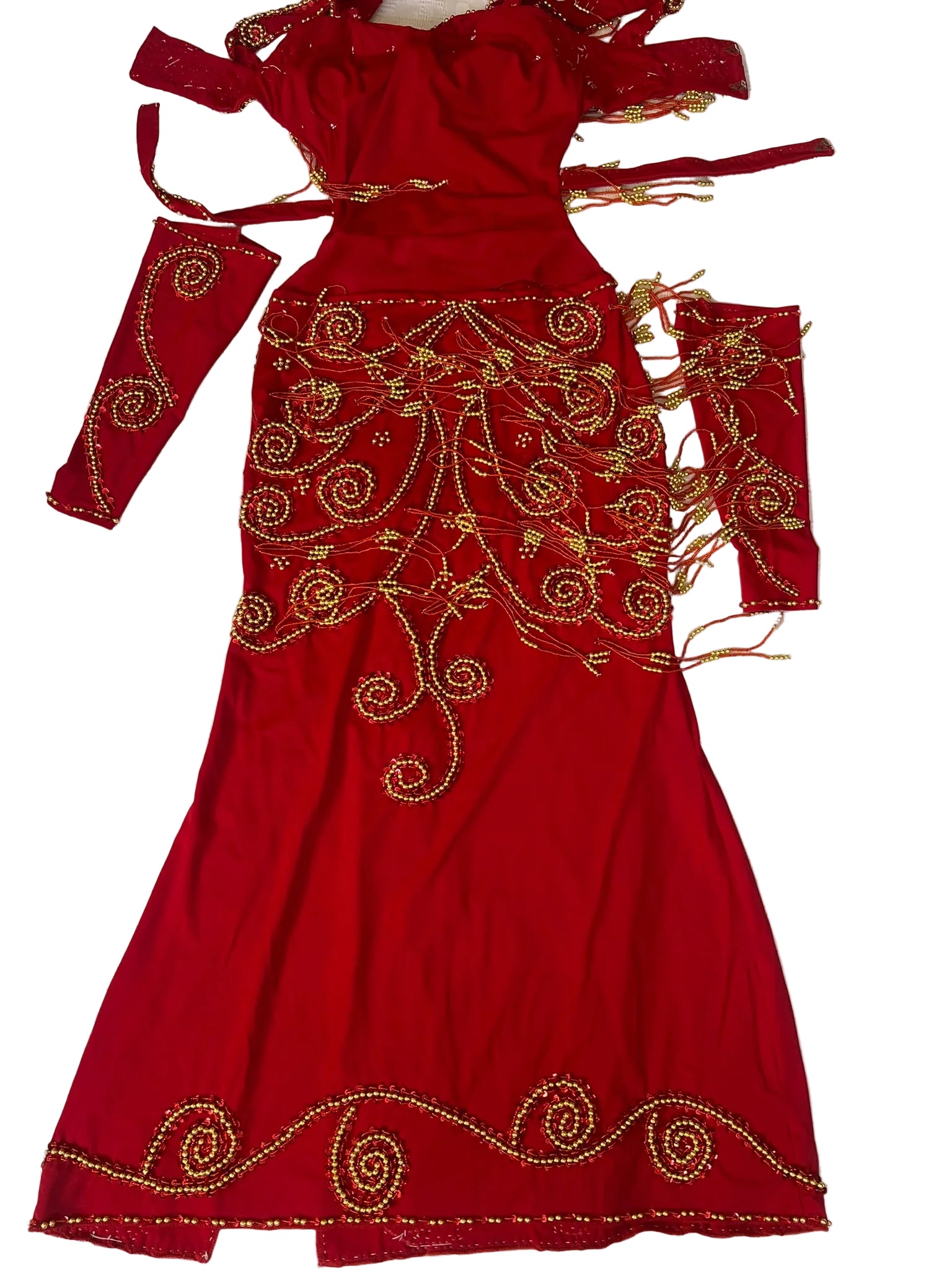 Red embroidered dress on a white bedspread