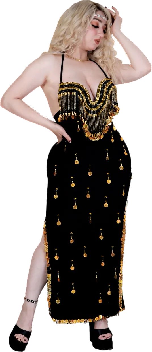 A woman wearing a black Egyptian belly dance costume with gold and silver sequins and embroidery.