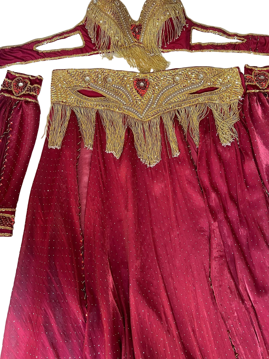 Maroon outfit with gold embroidery and fringes on a white background