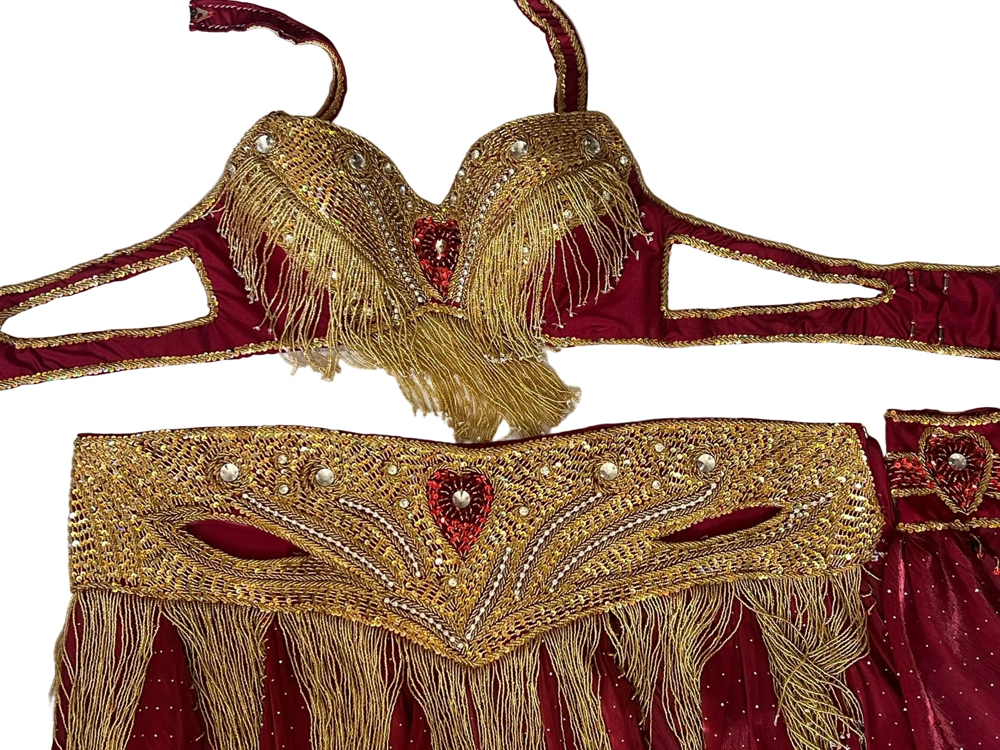Decorative gold and red dance garment with intricate patterns on a white background