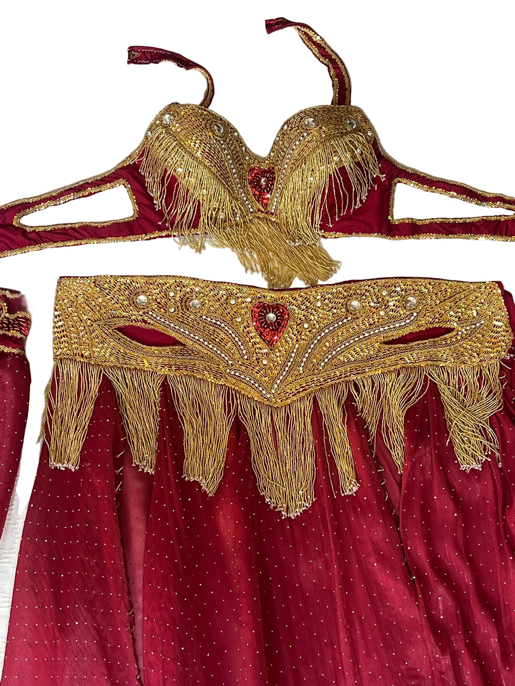 Red dress with gold embroidery and fringe on a white background