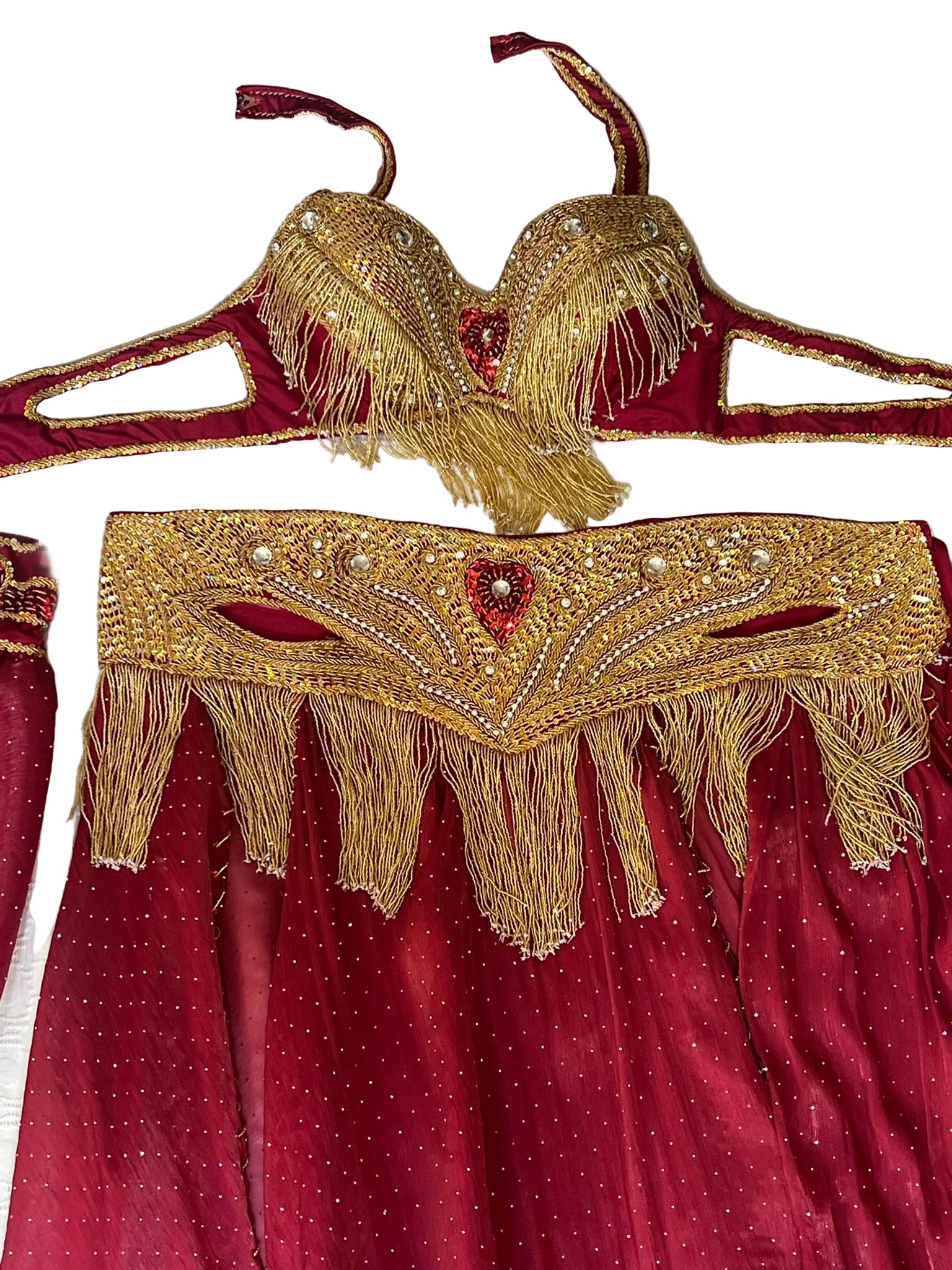 Red dress with gold embroidery and fringe on a white background