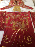 A professional red belly dance costume with gold, silver, and multicolored bead embellishments, including a skirt with a front slit, a bra, a chiffon veil, a pair of sleeves, and a headband.