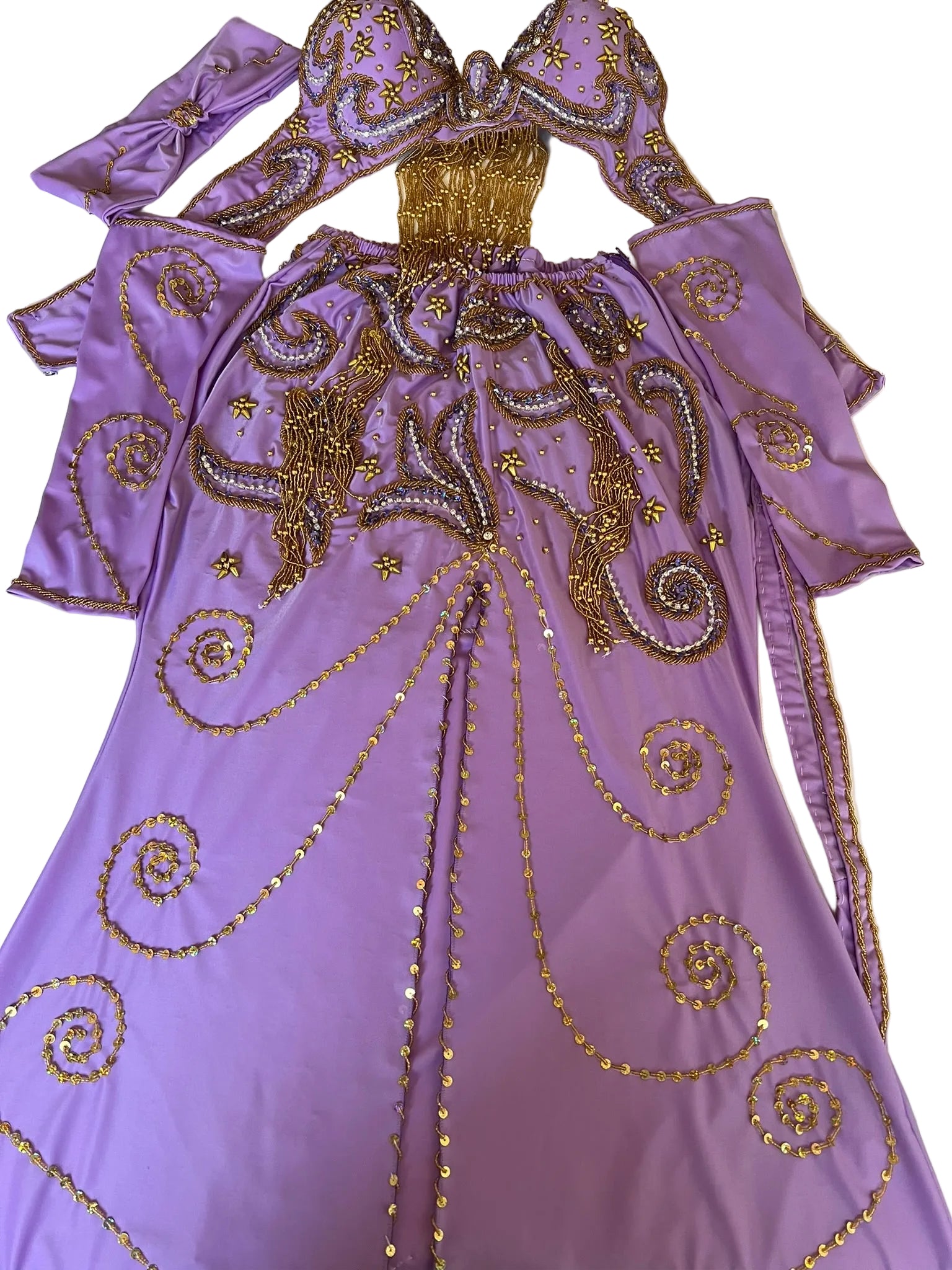 Purple dress with gold embroidery on a white surface