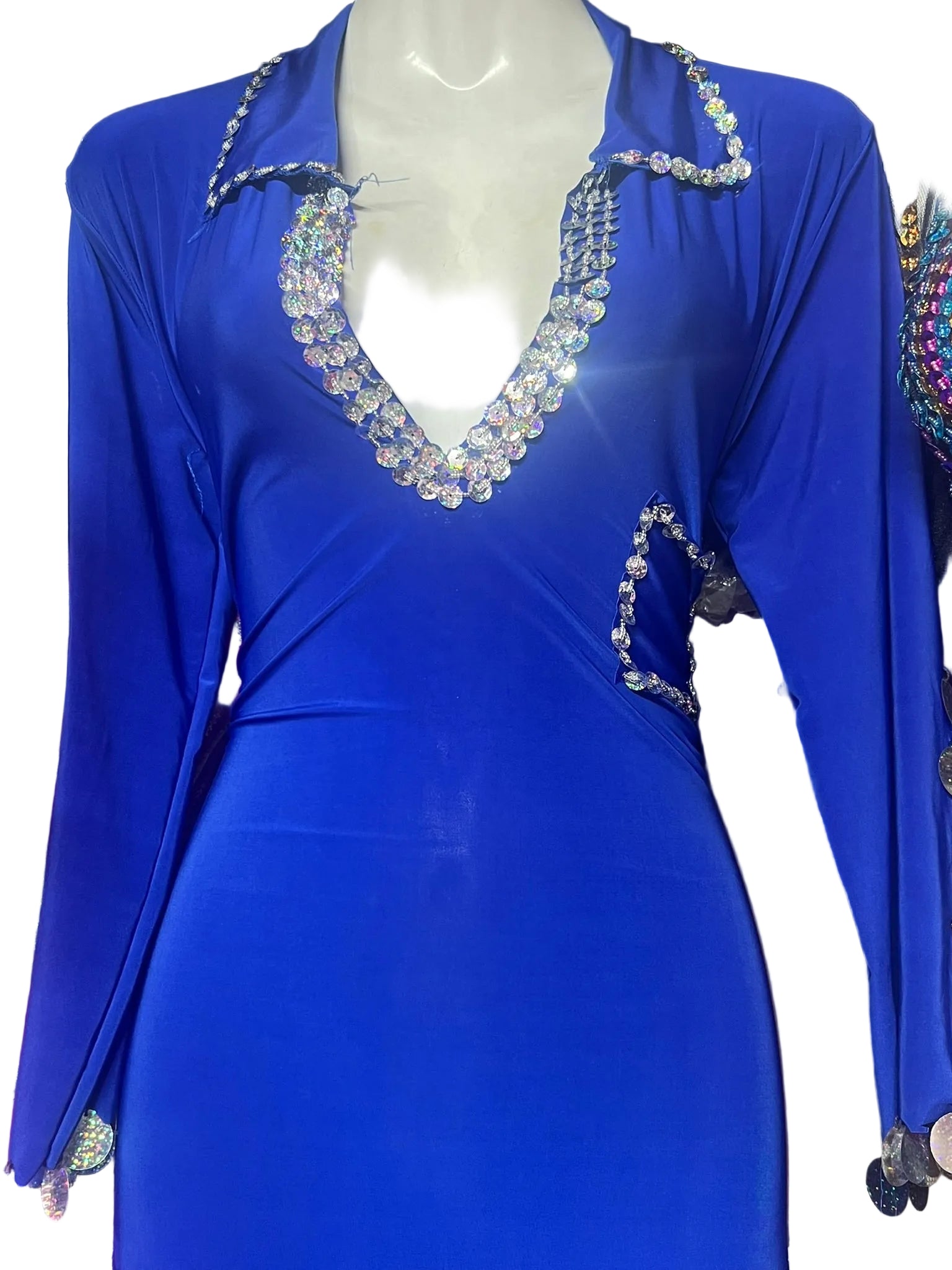 Blue dress with crystal embellishments on a mannequin against a dark background