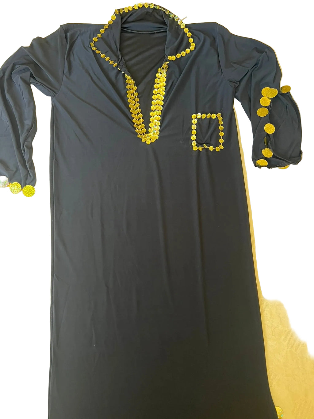 Gray dress with yellow embellishments on a beige surface