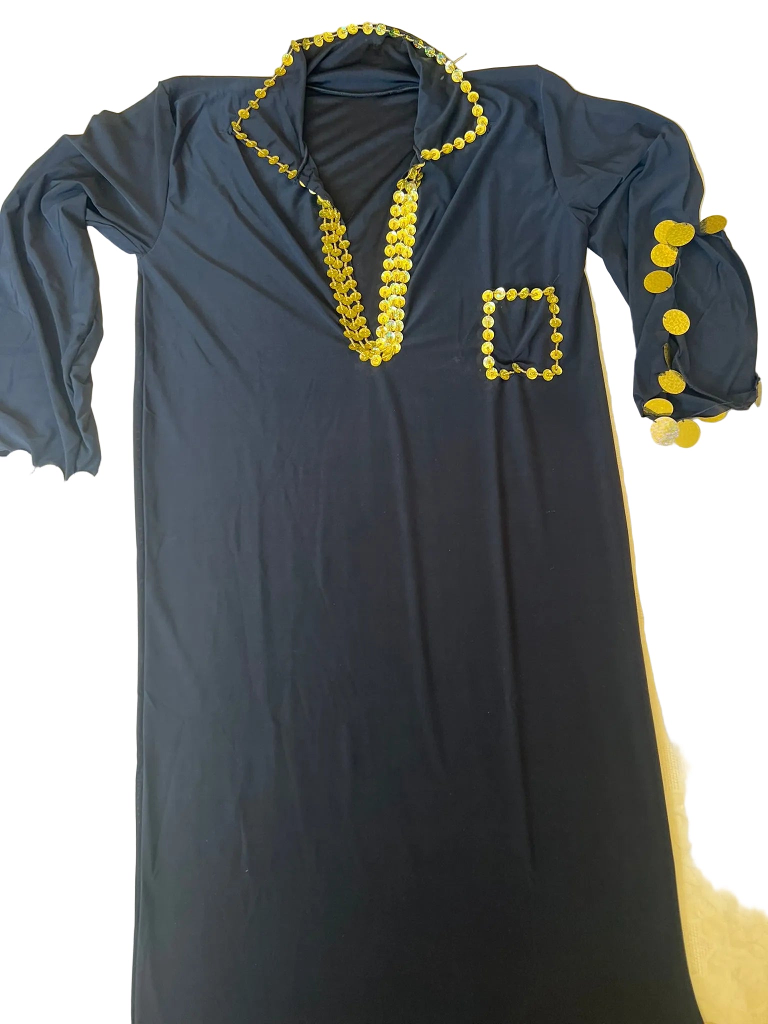 Dark blue dress with yellow embellishments on a beige surface