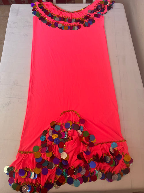 A stretchy pink belly dance dress with embellishments and handmade embroidery, displayed on a flat surface.