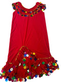 A red belly dance dress with handmade embroidery and multicolored accents laid out on a white surface.
