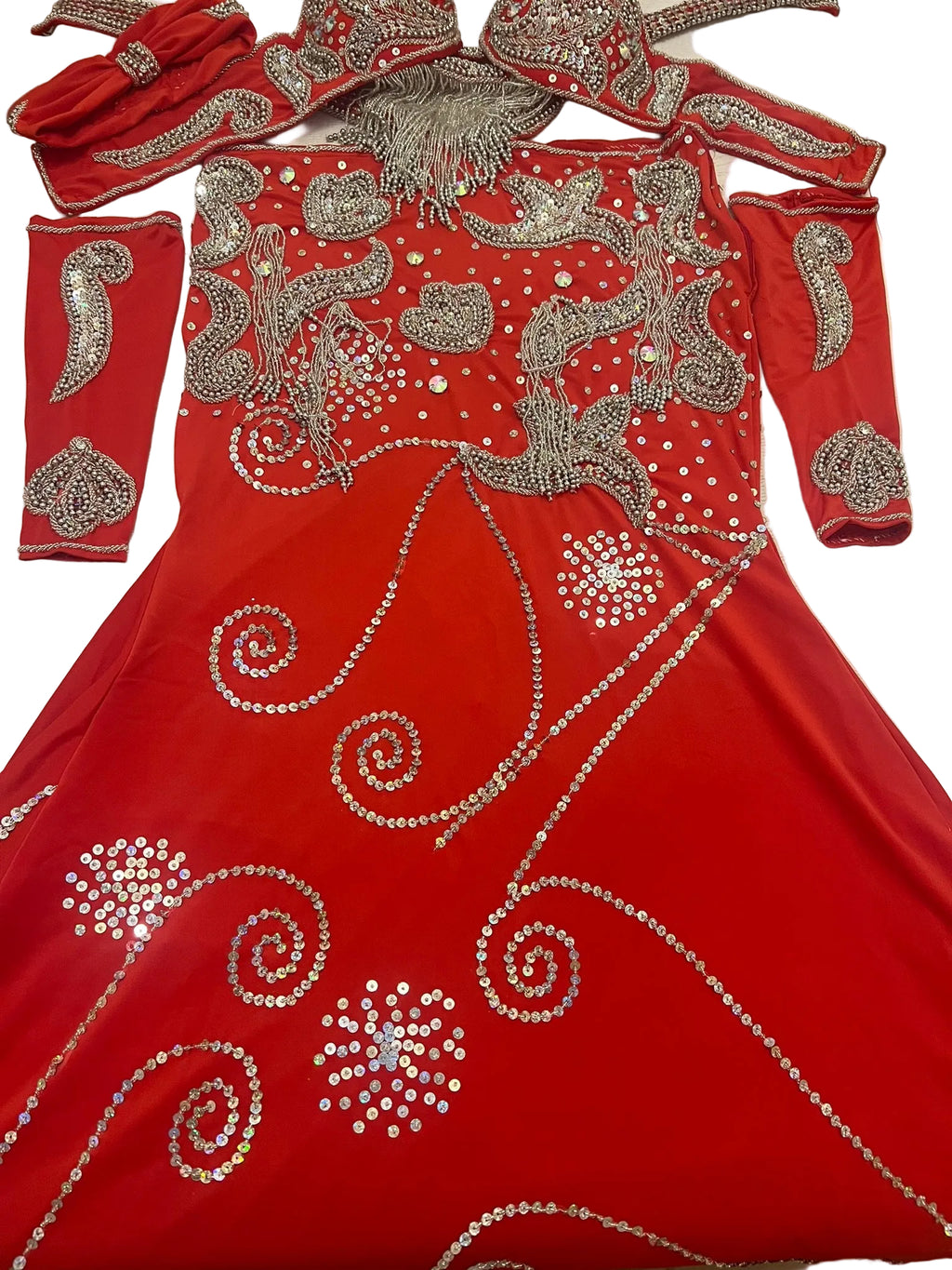 A red belly dance costume with sleeves and a headband, featuring extensive handmade embroidery with sequins and glass beads.
