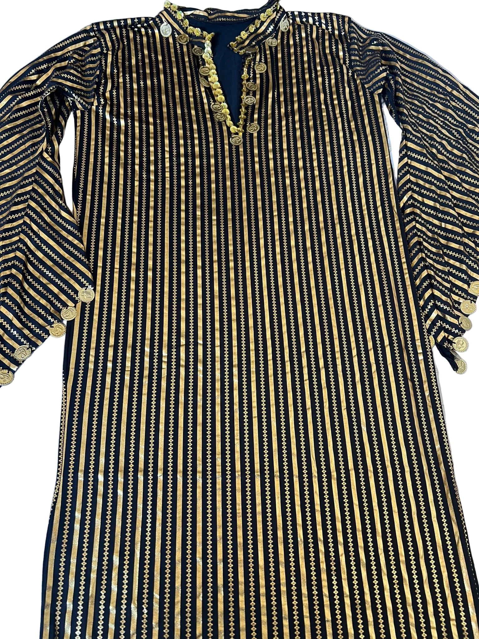 Black and gold striped dress with intricate detailing on a light blue surface