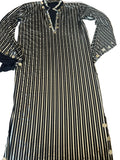 Black and white striped dress with button details on a white surface