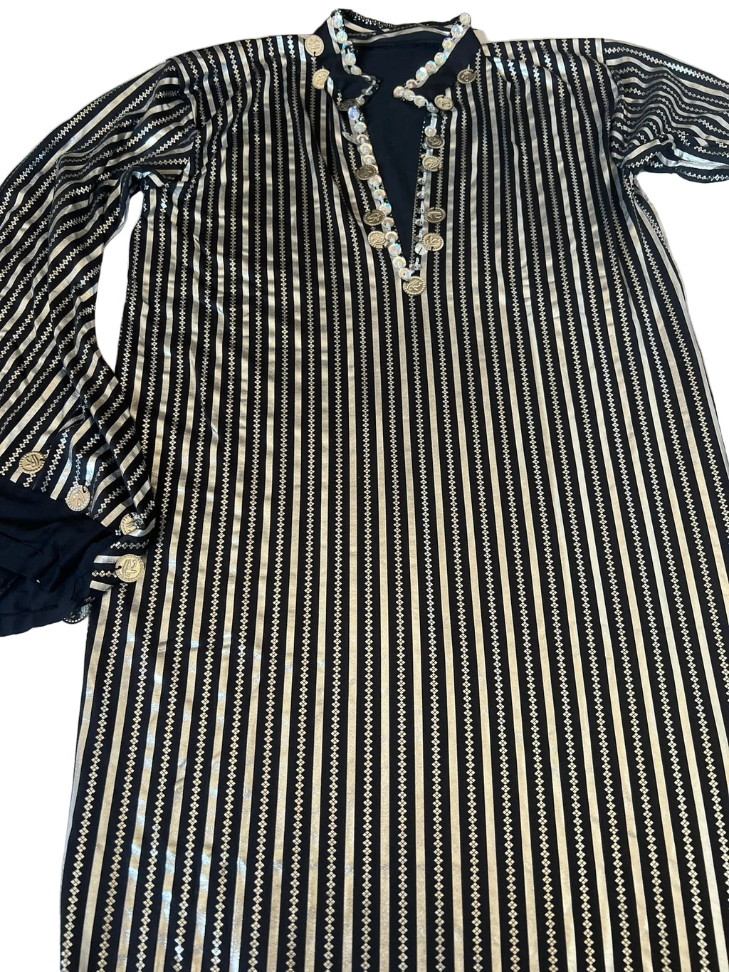 Black and white striped dress with decorative buttons on a white background