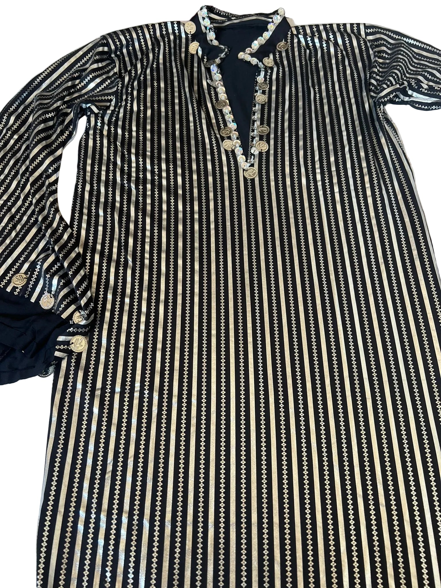 Black and white striped dress with decorative buttons on a white background