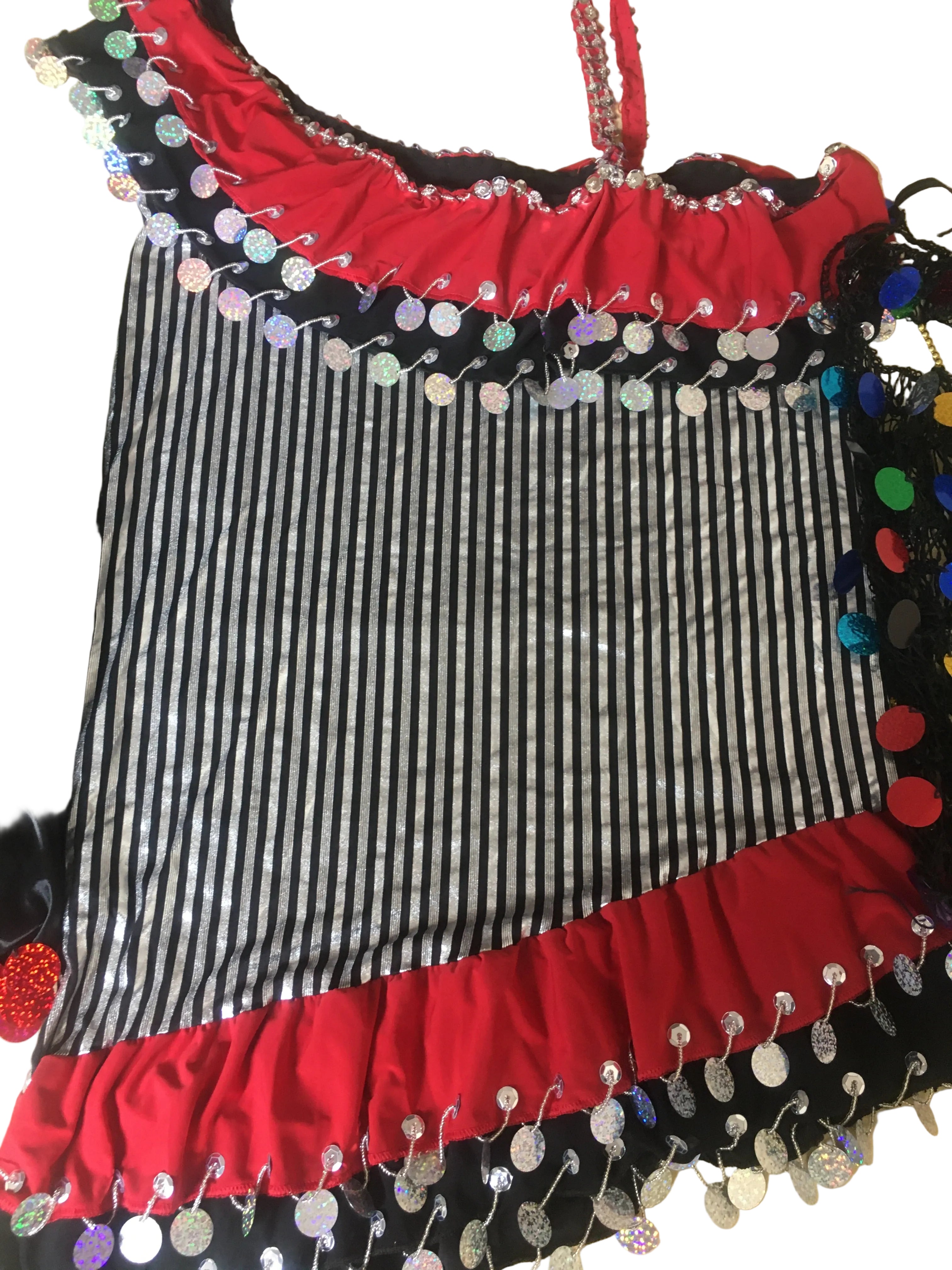 Striped fabric with decorative red and black border on a beige surface