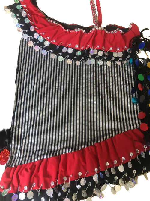 Striped fabric with decorative red and black border on a beige surface