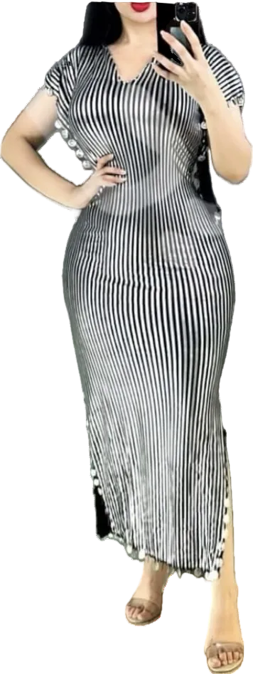Woman wearing a black and white striped dress with ruffled sleeves.
