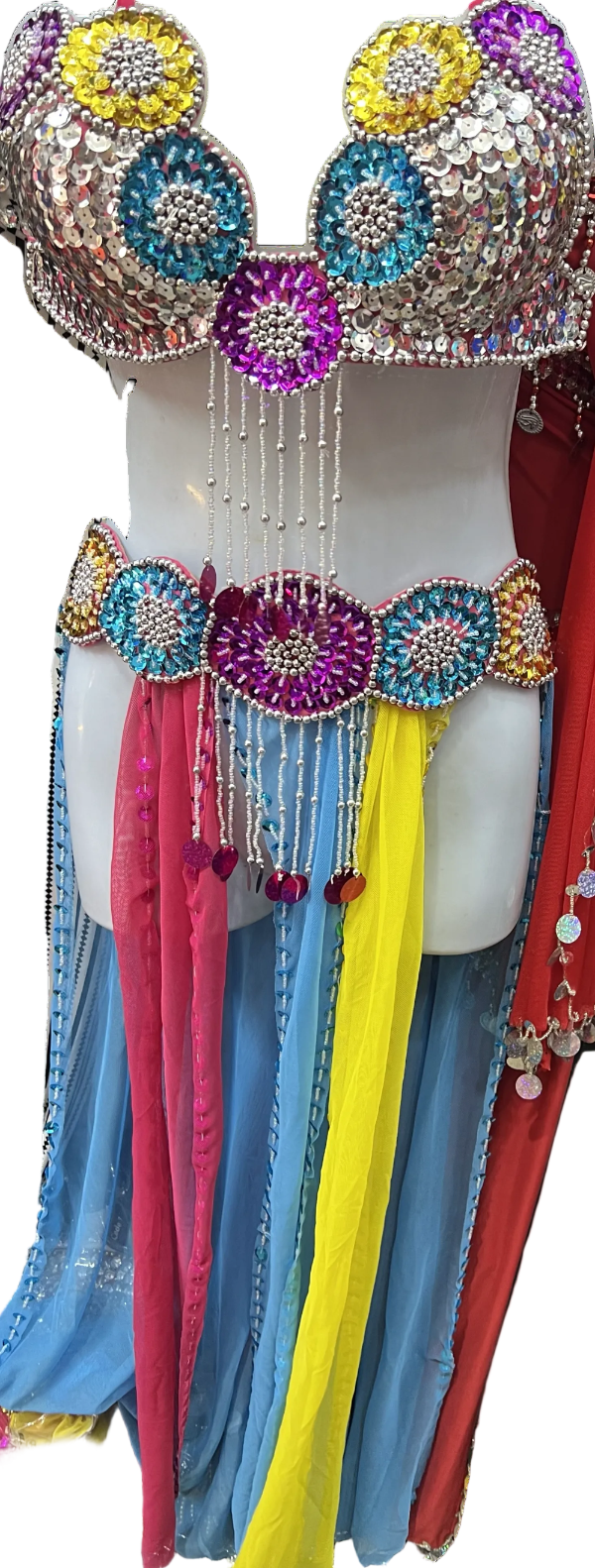 Colorful belly dance costume with sequins and long ribbons on a mannequin.