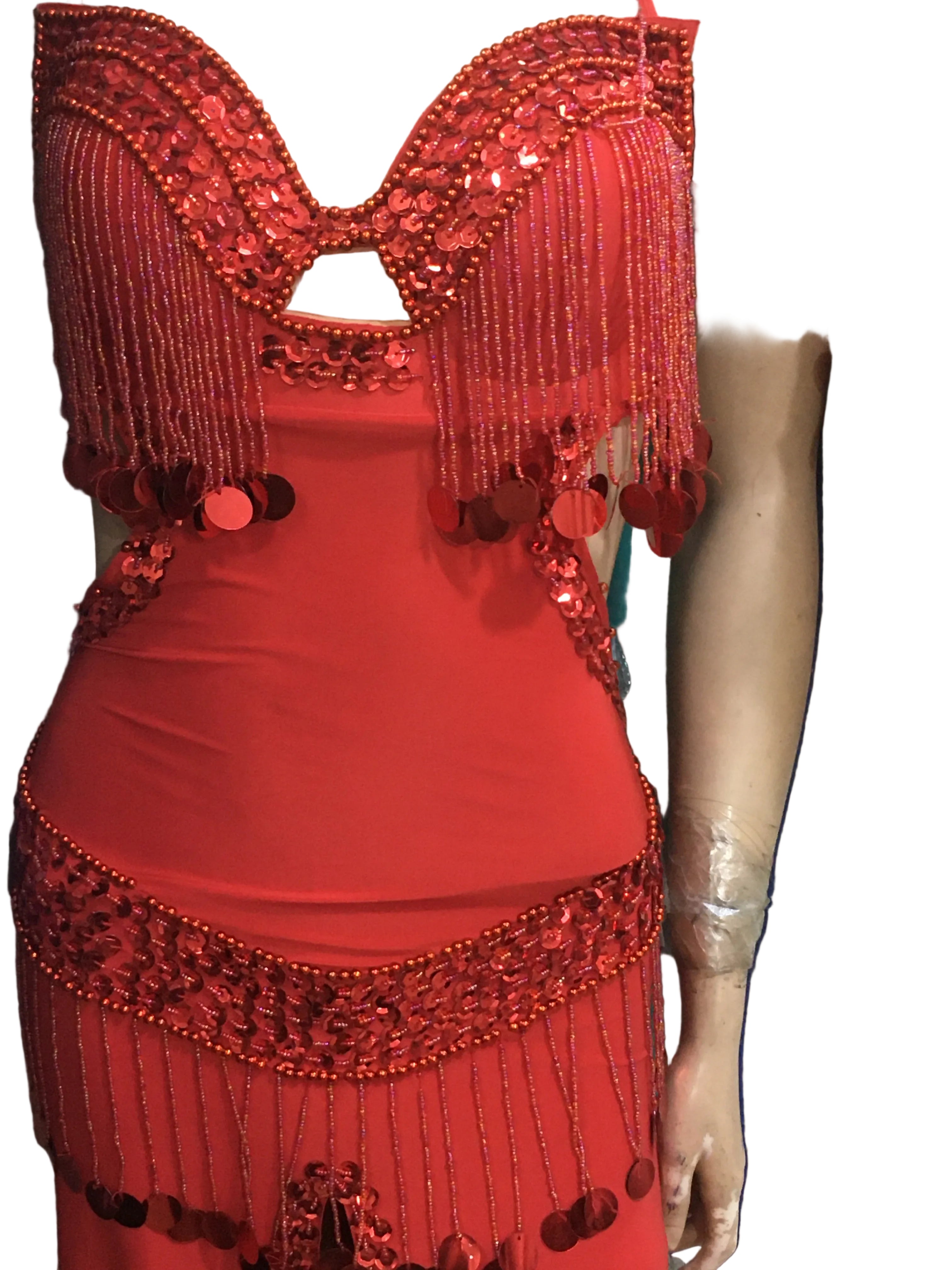 Red dress with intricate beading and embroidery on a person's arm.